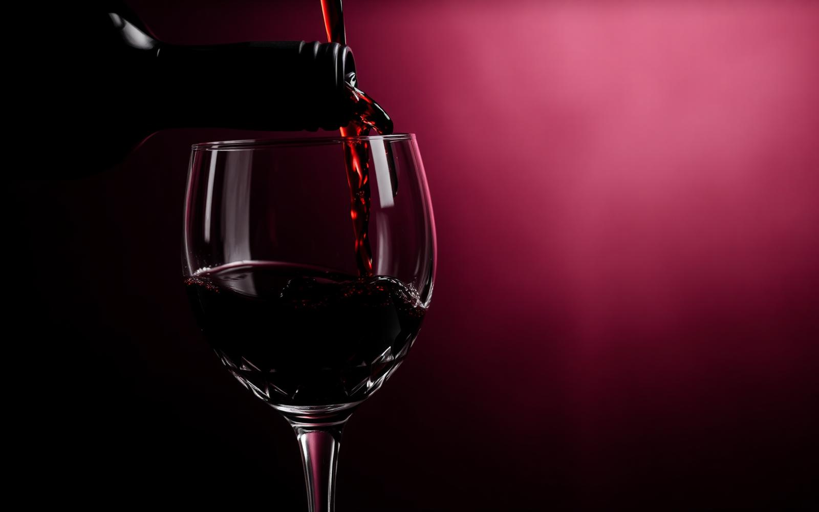 Pouring red wine into a glass